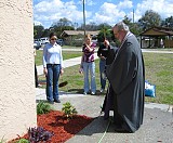 Fr. Joseph blesses the new plantings.